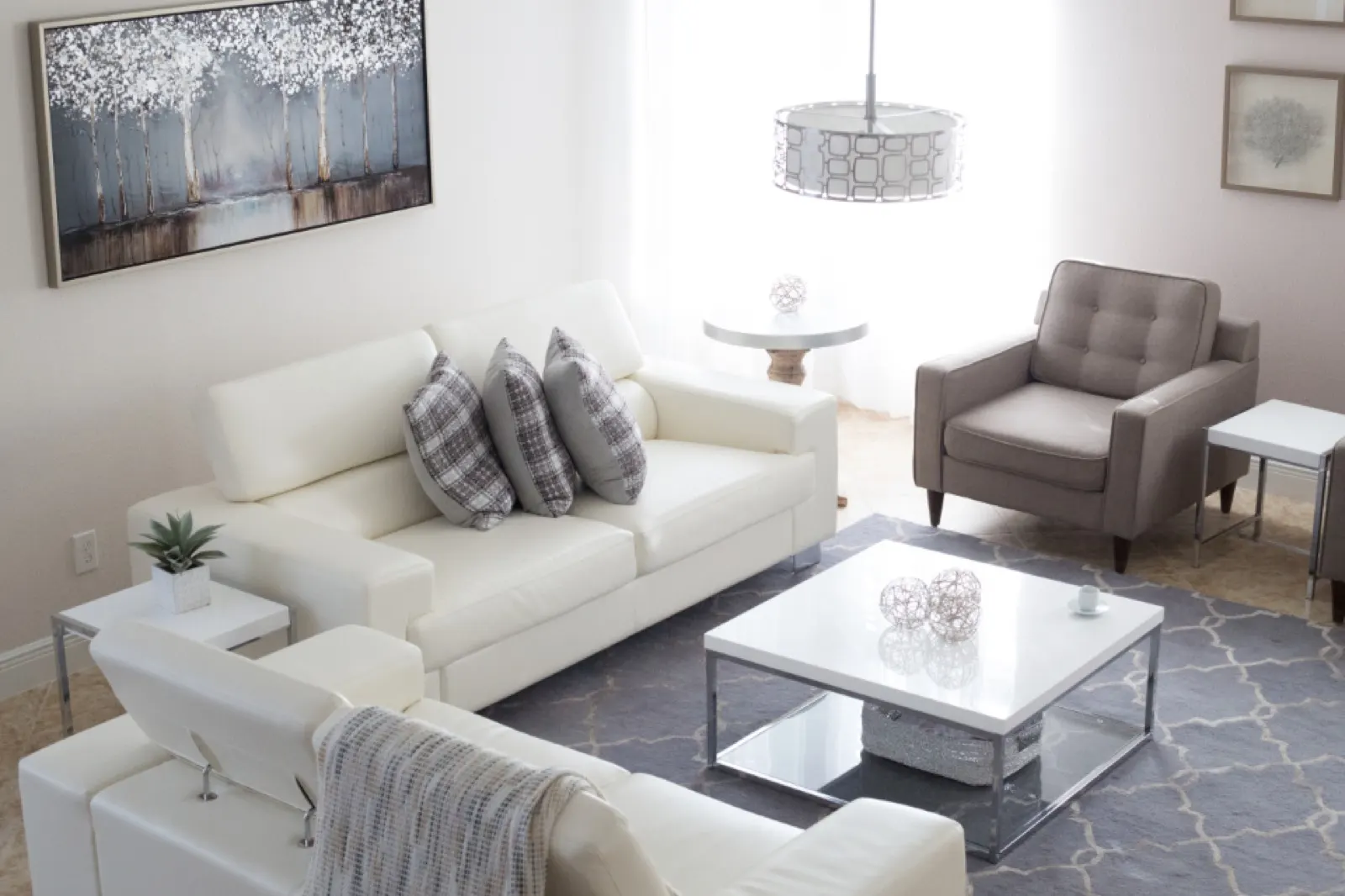 Bright living room with white sofas